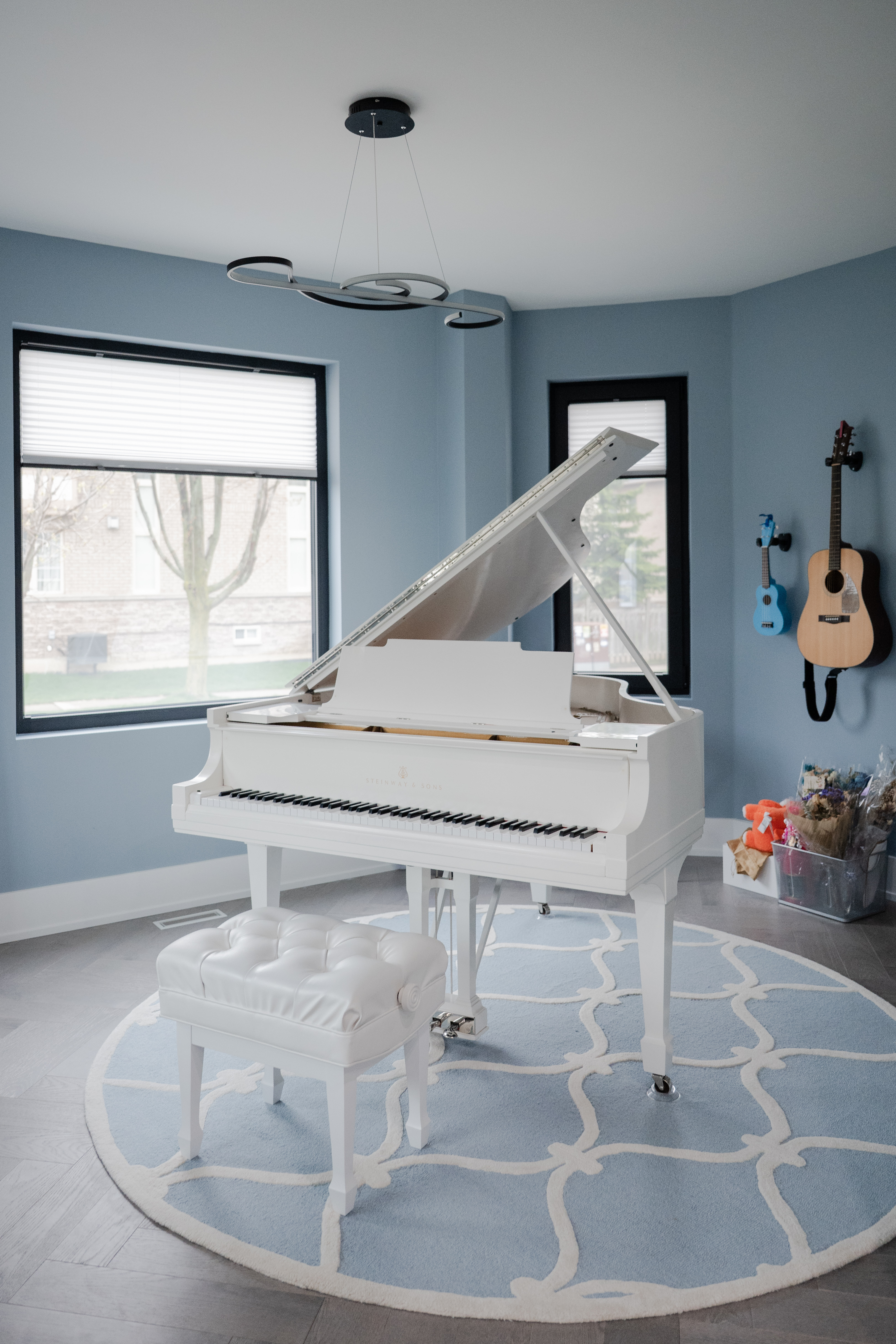 Vertical view of the white grand piano in Erin’s studio