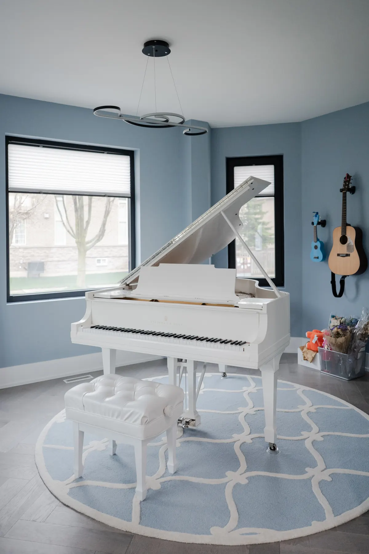 Vertical view of the white grand piano in Erin’s studio